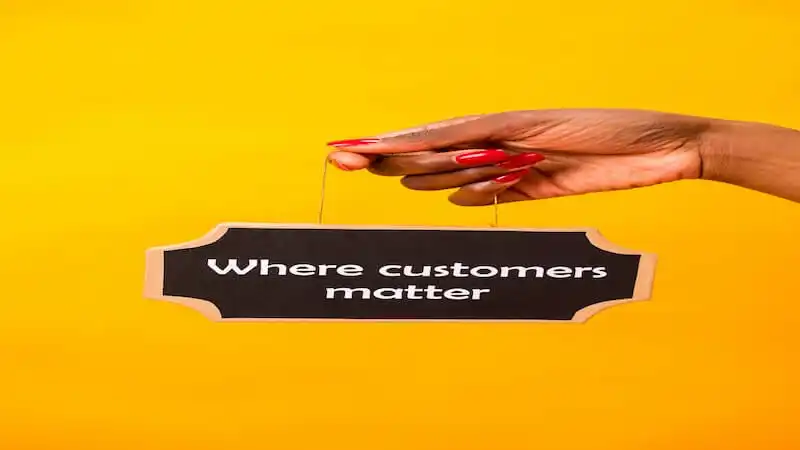 A person is holding a sign where it's writtenr "Where customers matter".