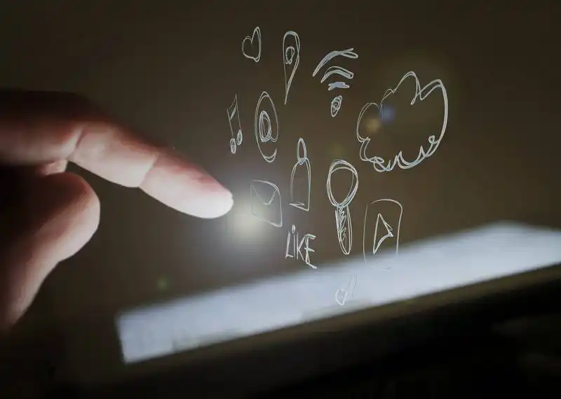 The image shows someone touchin a screen, and there are several icons coming out from the screen, such as cloud, wi-fi sign, YouTube's logo, and a heart.
