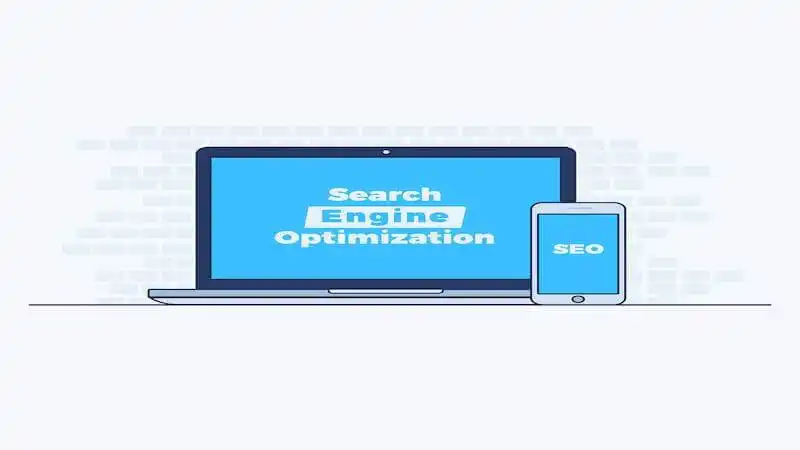 The image shows a laptop, where it's written "Search Engine Optimization", and a smartphone, where it's written "SEO".