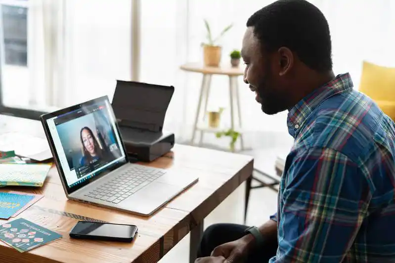 A salesperson working in an office on a virtual call. 