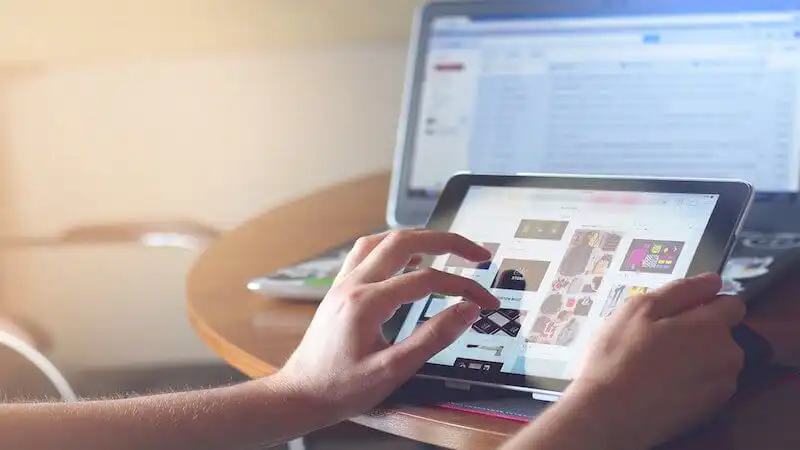 The image shows someone using a tablet