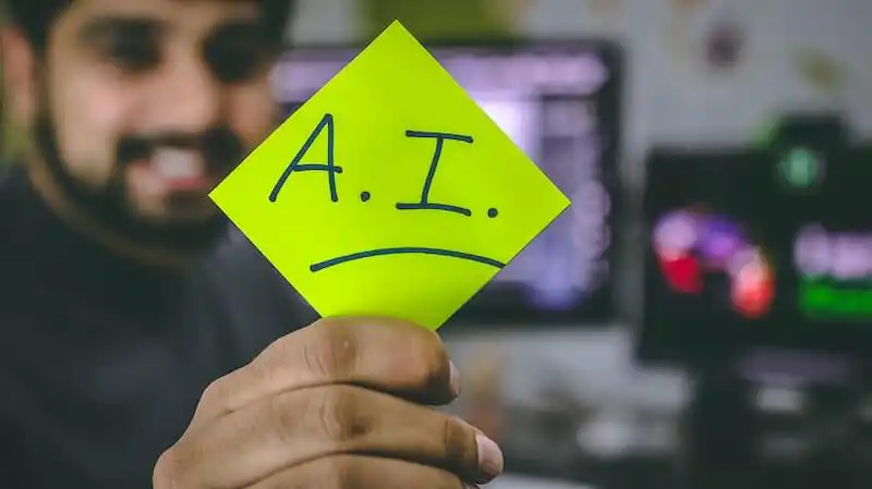 AI Marketing The image shows a person holding a post-it where it's written "A.I."