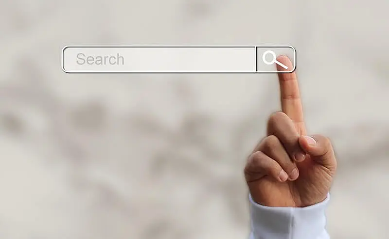 The image shows a person touching a search bar