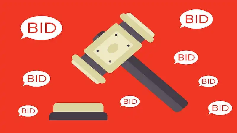 The image shows an auction hammer in the middle and around it there are several balloons with the word "Bid" written inside of them.