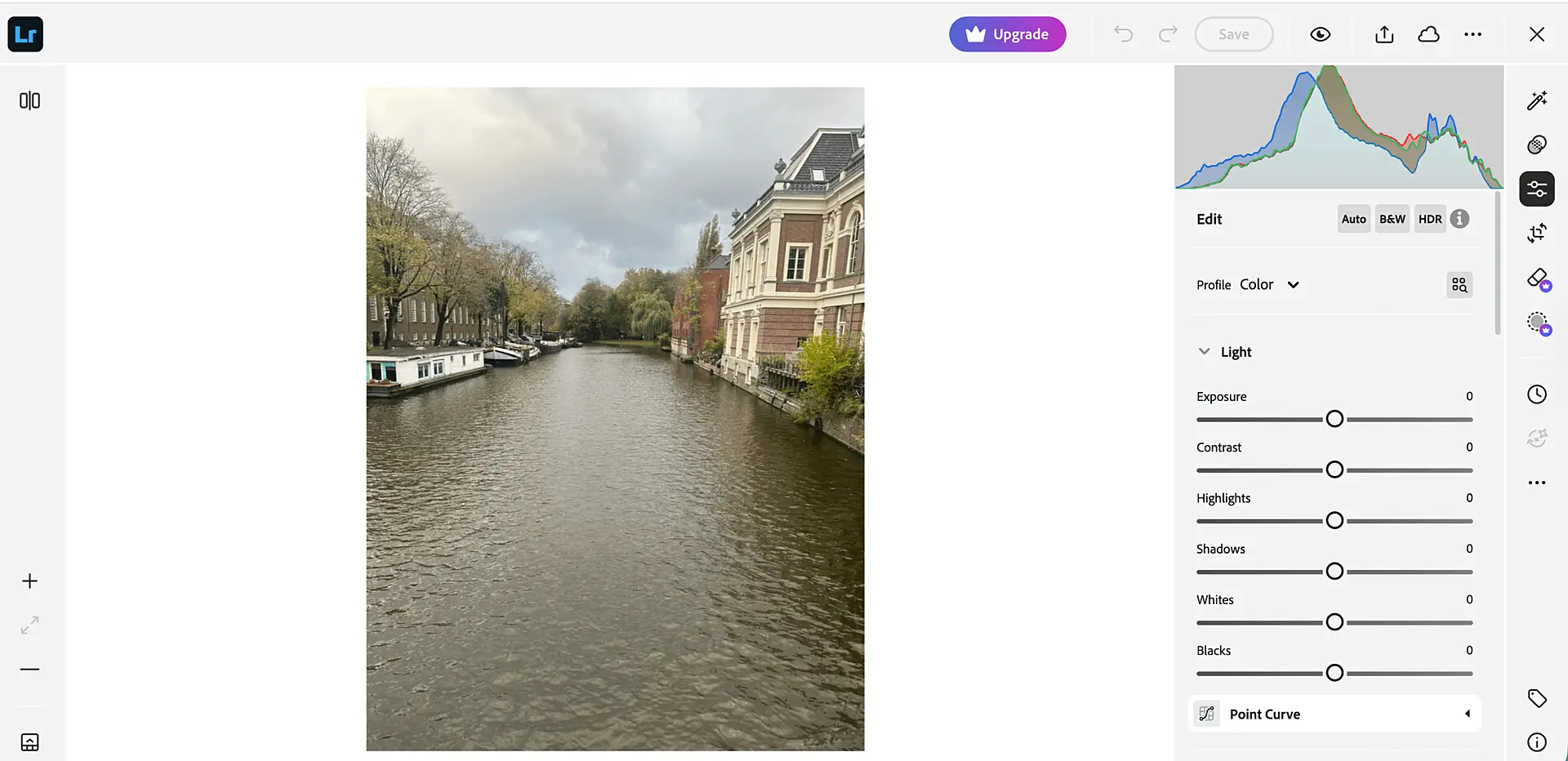 Adobe Lightroom editing interface showing a canal photo with light and color adjustment sliders and histogram on the right side.