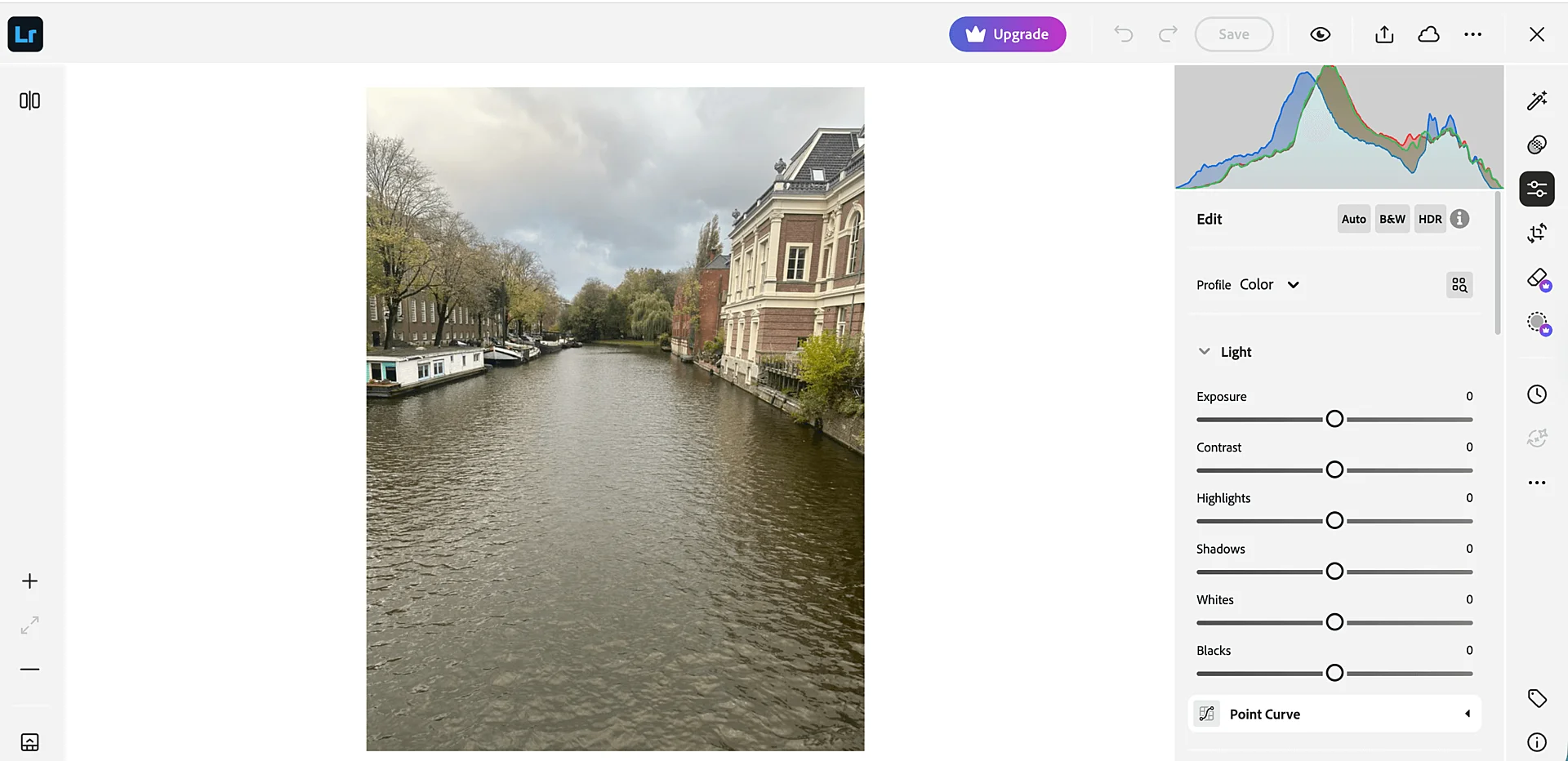 Adobe Lightroom editing interface showing a canal photo with light and color adjustment sliders and histogram on the right side.