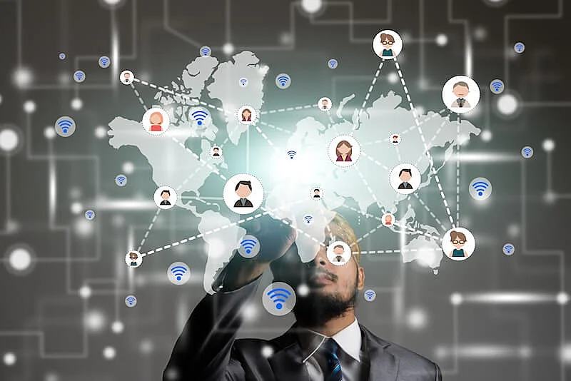 The image shows a world map with an illustration of people connected by lines in front of it.