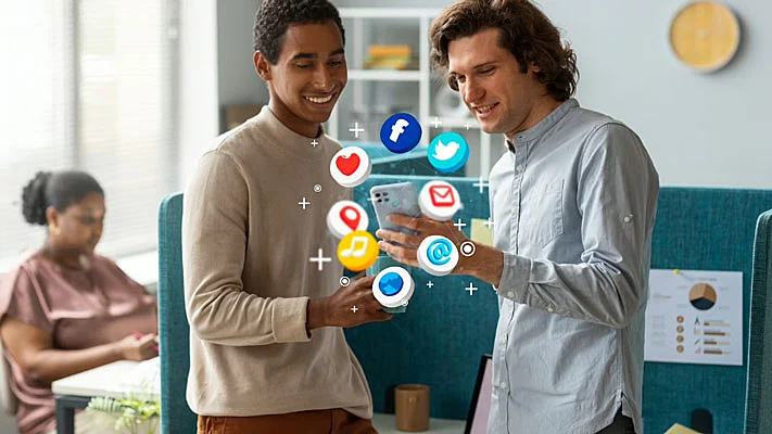 Foto de dos chicos manejando móviles con íconos 3D de redes sociales