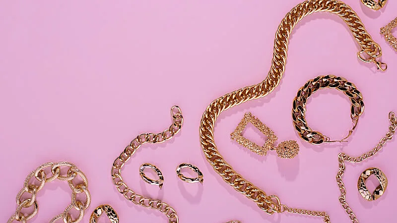 bijuterias sendo apresentadas ao lado de um vaso de planta