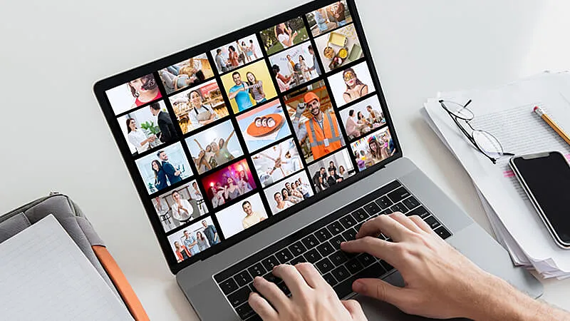 Foto de uma pessoa vendo banco de imagens no notebook