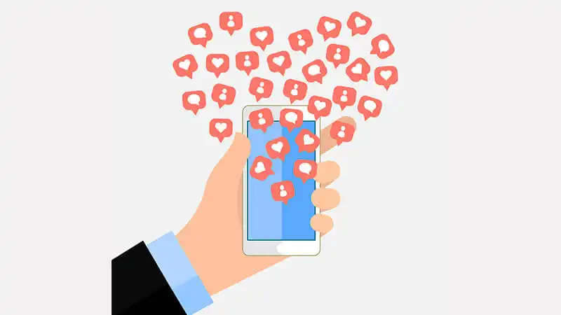 Ilustração de uma mão segurando um celular com a logo do Instagram