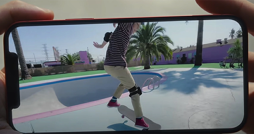 Person holding a smartphone with a picture of someone staking