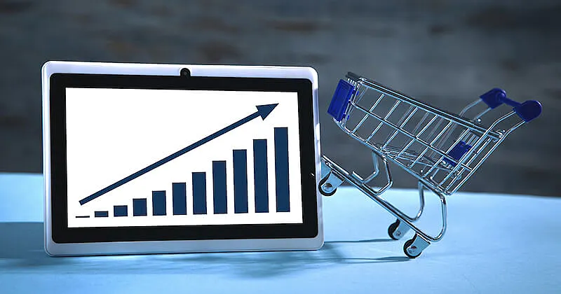 A tables screen shows a crescent graphic, and on the tablet right side there is a shopping cart miniature.