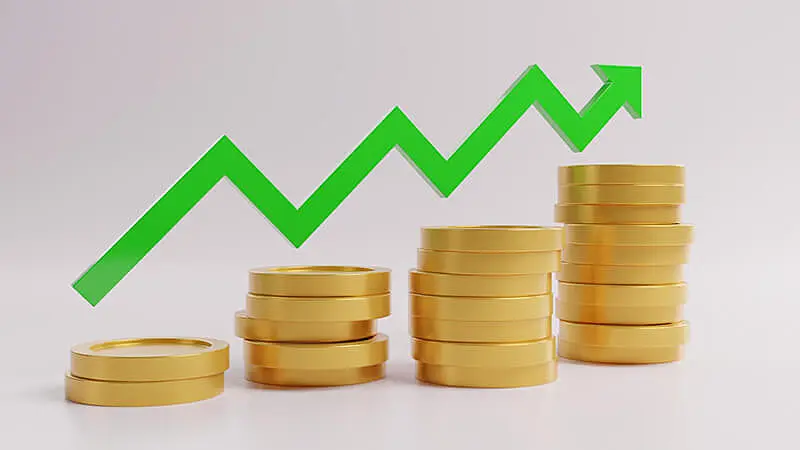 Imagem de pilhas de moedas e uma seta verde subindo