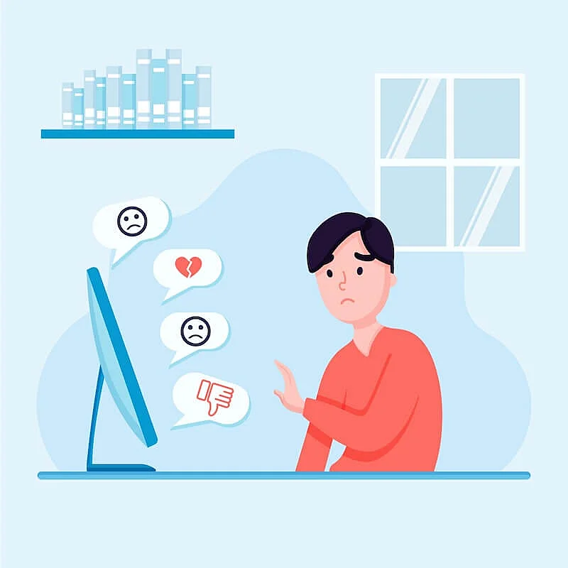 The image shows an illustration o a man looking com a computer screen with a sad face. There are also sad emojis appearing in speech baloons.