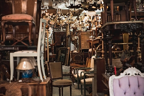 The image shows a store full of old furniture