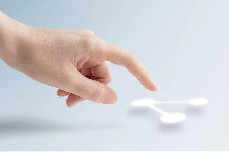 A human hand touching a connection symbol