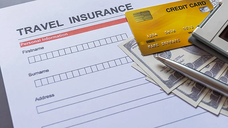 Foto de um contrato de seguro e uma mão segurando uma caneta