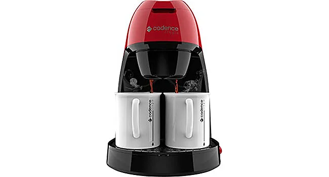foto de uma mini cafeteira Single da Cadence na cor vermelha servindo duas xícaras de café brancas