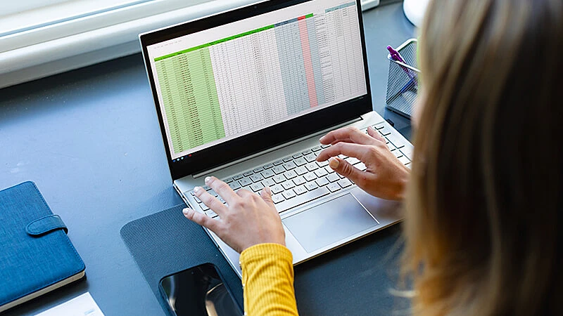 Foto de um homem utilizando o Excel em um computador