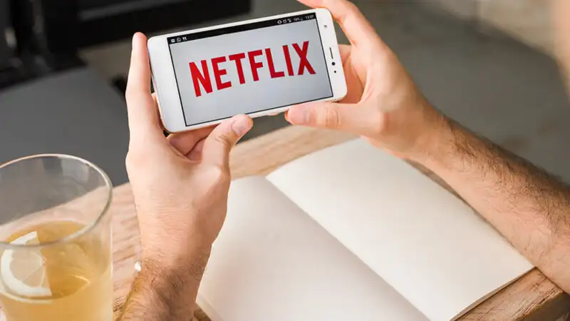 logo do Nord VPN ao lado de um notebook com a Netflix aberta