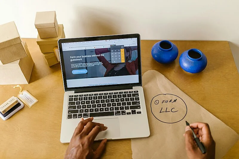 The image shows a person using a laptop. 