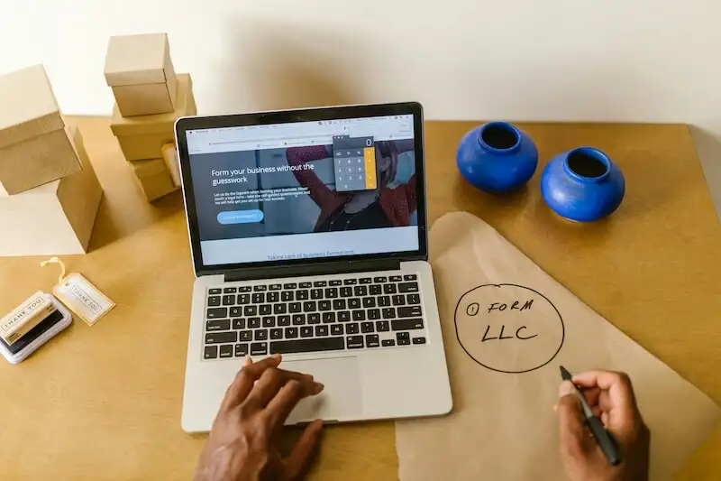 The image shows a person using a laptop. 