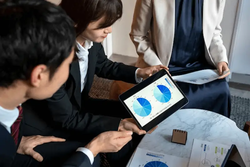 The image shows 3 people in a meeting