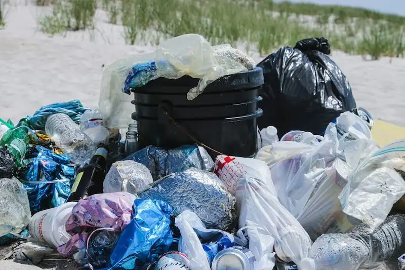 The image shows several bags full of trash
