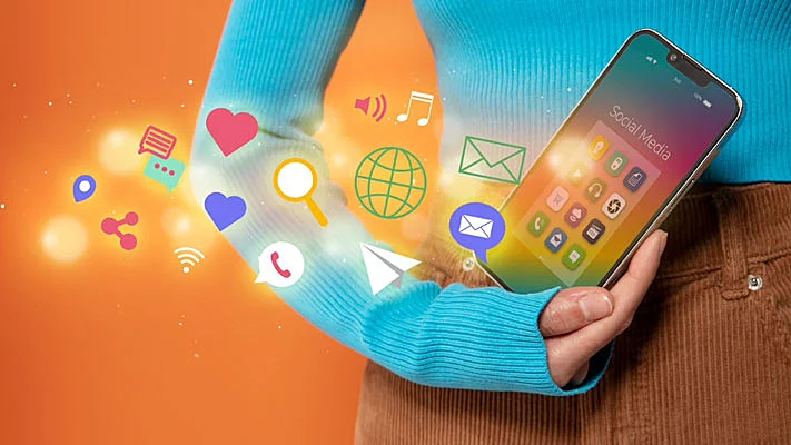 Foto de una mujer cogiendo el móvil con diferentes íconos de internet em proyección