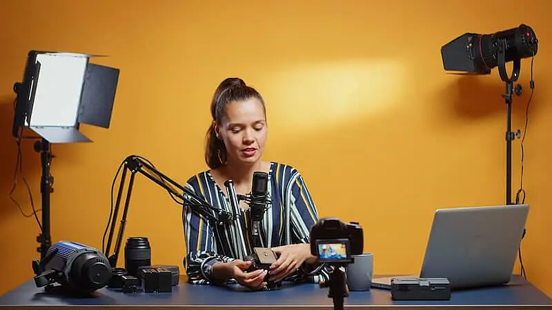 The images shows a woman recording a video. 