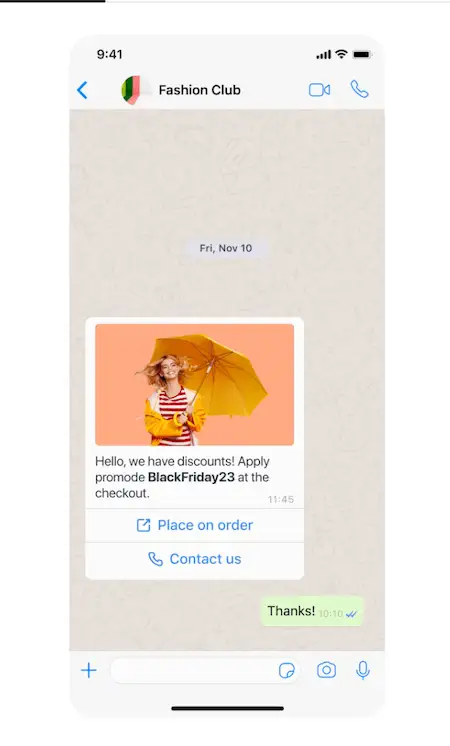 WhatsApp automation for business - marketing campaigns WhatsApp message from Fashion Club showing a promotional offer with a photo of a smiling woman holding a bright orange umbrella. The message promotes a Black Friday discount code "BlackFriday23" with buttons to place an order or contact the business.