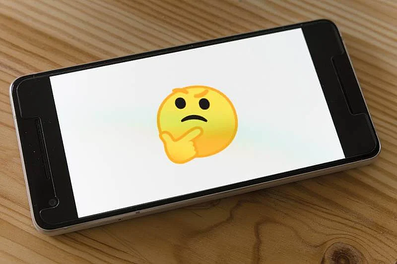 The images shows a thinking face emoji in a smartphone screen