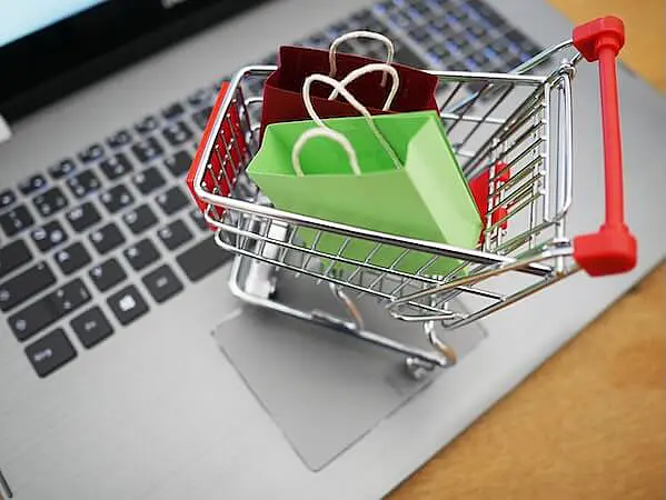 The image shows a shopping cart on a laptop keyboard