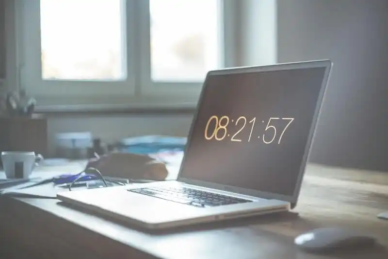 The image shows a laptop on a table. 